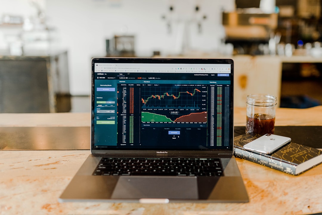 Computer screens displaying automated trading strategy charts and algorithmic forex systems